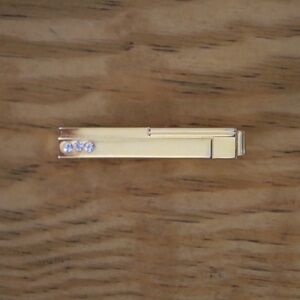 Gold, jewled tie bar